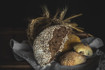 Different fresh bread on old wooden table