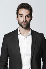 Suave guy in suit, smiling