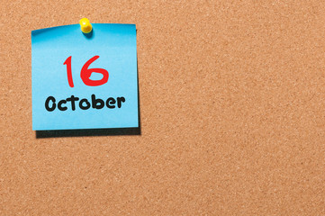 October 16th. Day 16 of month, color sticker calendar on notice board. Autumn time. Empty space for text