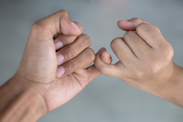 hook each other's little ; be hand in hand