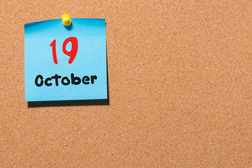 October 19th. Day 19 of month, color sticker calendar on notice board. Autumn time. Empty space for text