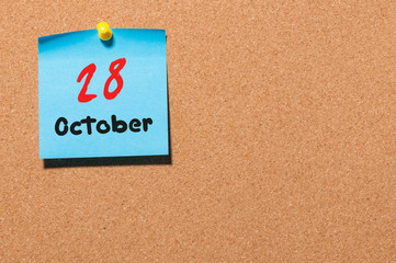 October 28th. Day 28 of month, color sticker calendar on notice board. Autumn time. Empty space for text