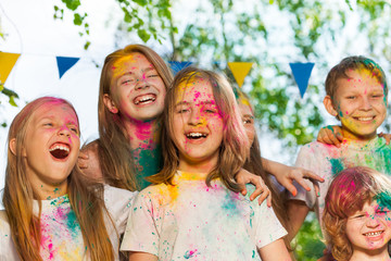 Portrait of happy kids smeared with colored powder
