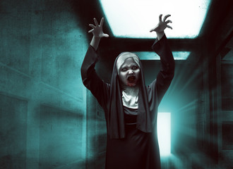 Scary asian nun with bloody mouth raise up hand