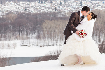 Winter wedding. Beautiful young couple bride and groom