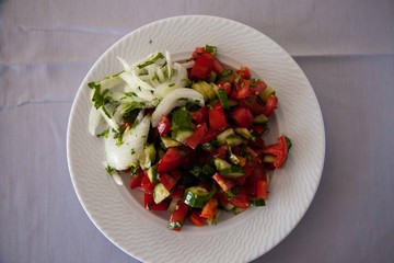 Salad with tomatoes and cucumbers in the plate