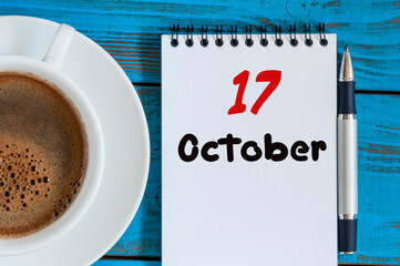 October 17th. Day 17 of month, calendar near coffee cup at Network Systems Analyst workplace...