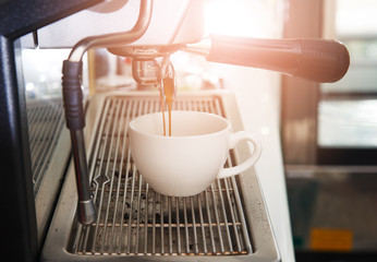 espresso coffee machine with filter make coffee flowing into a c