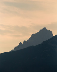 Fototapeta na wymiar Highlighted rocky peaks of mountains