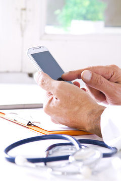 stethoscope with doctor's hands and mobile phone