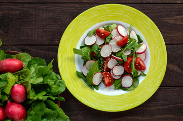 Fresh vitamin fitness salad with radish, arugula and sesame. The top view.