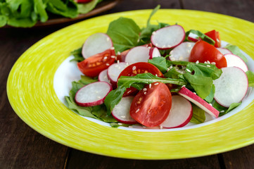 Fresh vitamin fitness salad with radish, arugula and sesame. Close up