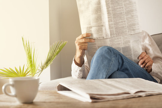 Man Reading Newspaper In Home