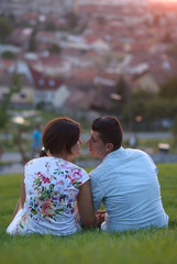 Couple sitting on the grass and kissing