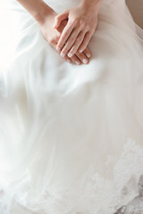 Fototapeta na wymiar Bride hands on wedding dress