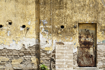 door and old yellow wall
