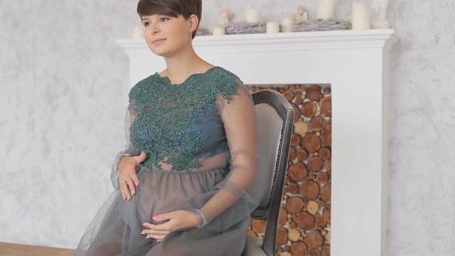 Close up of pregnant woman sitting in chair