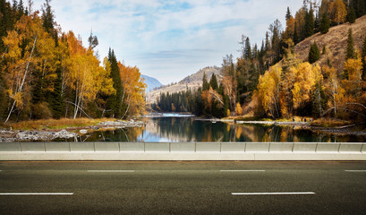 Empty asphalt road and lake mountain background .