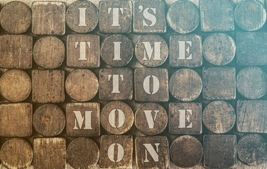 Time to move on. Motivational message written on wooden tiles