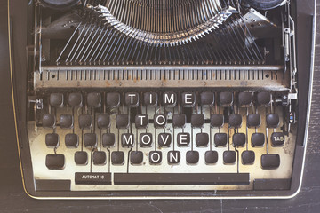 Time to move on. Motivational message written on vintage typewriter keys