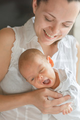 Newborn baby boy in mother's arms
