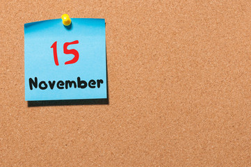 November 15th. Day 15 of month, color sticker calendar on notice board. Autumn time. Empty space...