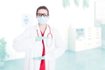 Beautiful surgeon holding something between palms