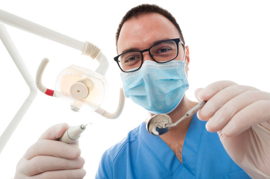 Hygienist wearing mask making consultation holding tools