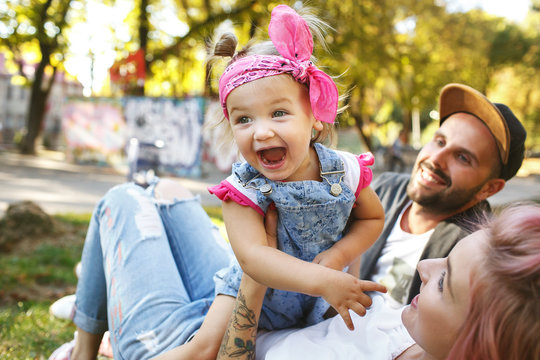 Funny picture of screaming little girl with pink kerchief sittin