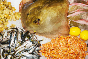 Fresh raw sea food with lemons on ice.