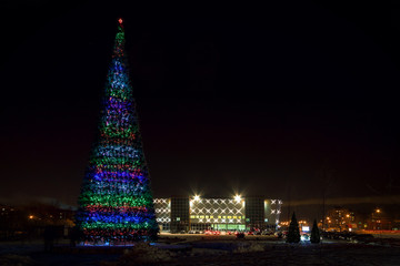 Night city, decorated with Christmas lights. Downtown, the area night. The photo was taken at a wide angle, long exposure mode. Christmas City