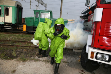 Fototapeta premium firemen in action, Firefighters exercises train accident, chemical contamination 