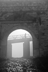 Fortress gate and wooden bridge in fog at autumn morning, Kalemegdan, Belgrade, Serbia