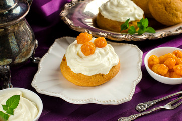 Dessert with cream and berries cloudberries.