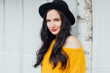 Beautiful young woman in black hat 