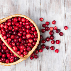 Harvest fresh red cranberries in wicker basket, top view
