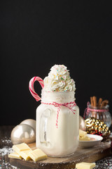 Hot white chocolate with whipped cream and candy cane. Christmas winter concept