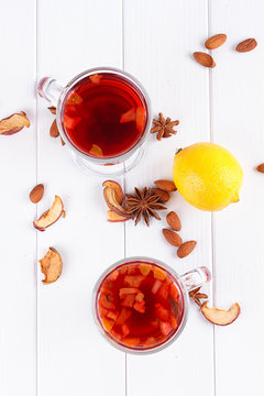 Glass cup of tea with hibiscus and lemon, cinnamon