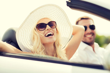 happy man and woman driving in cabriolet car