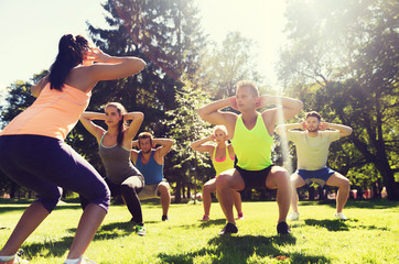 group of friends or sportsmen exercising outdoors - Powered by Adobe