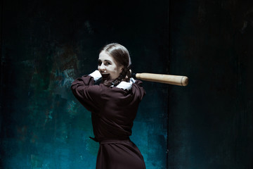 Portrait of a young girl in school uniform as killer woman