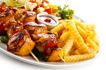 Kebab - grilled meat and vegetables on white background 