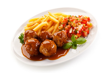 Roasted meatballs, chips and vegetables 