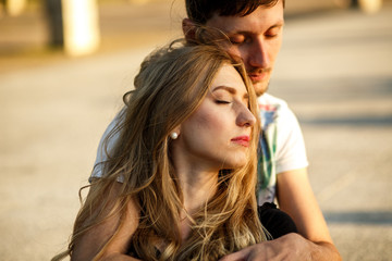 Young couple enjoys moment of peace while they sit on the street