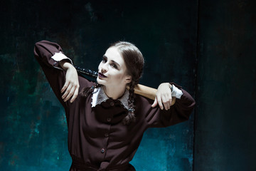 Portrait of a young girl in school uniform as killer woman