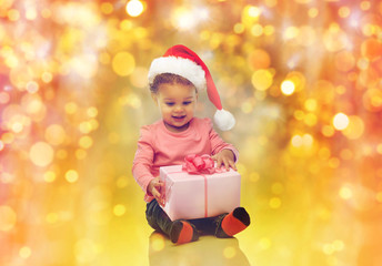 Fototapeta na wymiar happy little baby girl with christmas present