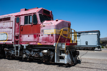 Old grungy abandoned and decaying locomotive parked in a rail yard