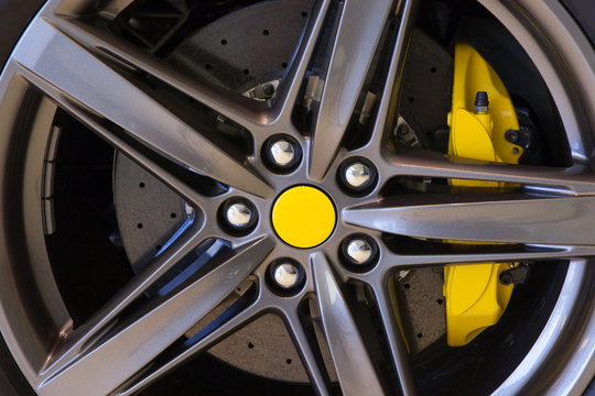Sports Car Wheel With Carbon Ceramic Disc And Yellow Brake Caliper

