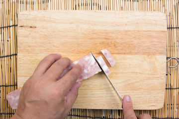 chef cutting bacon for cooking fired rice