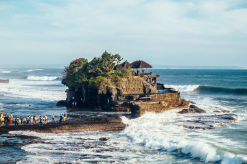 Outdoors sea view near Tanah Lot temple with line of people, Bali. Indonesia nature landscape in sunny daylight © moeimyazanyato